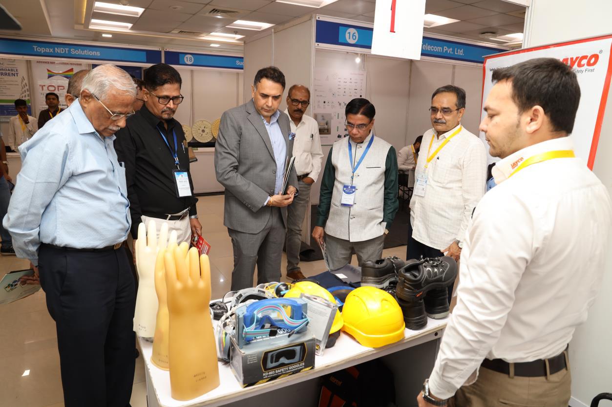 Chief guest observing products displayed in one stall in exhibition